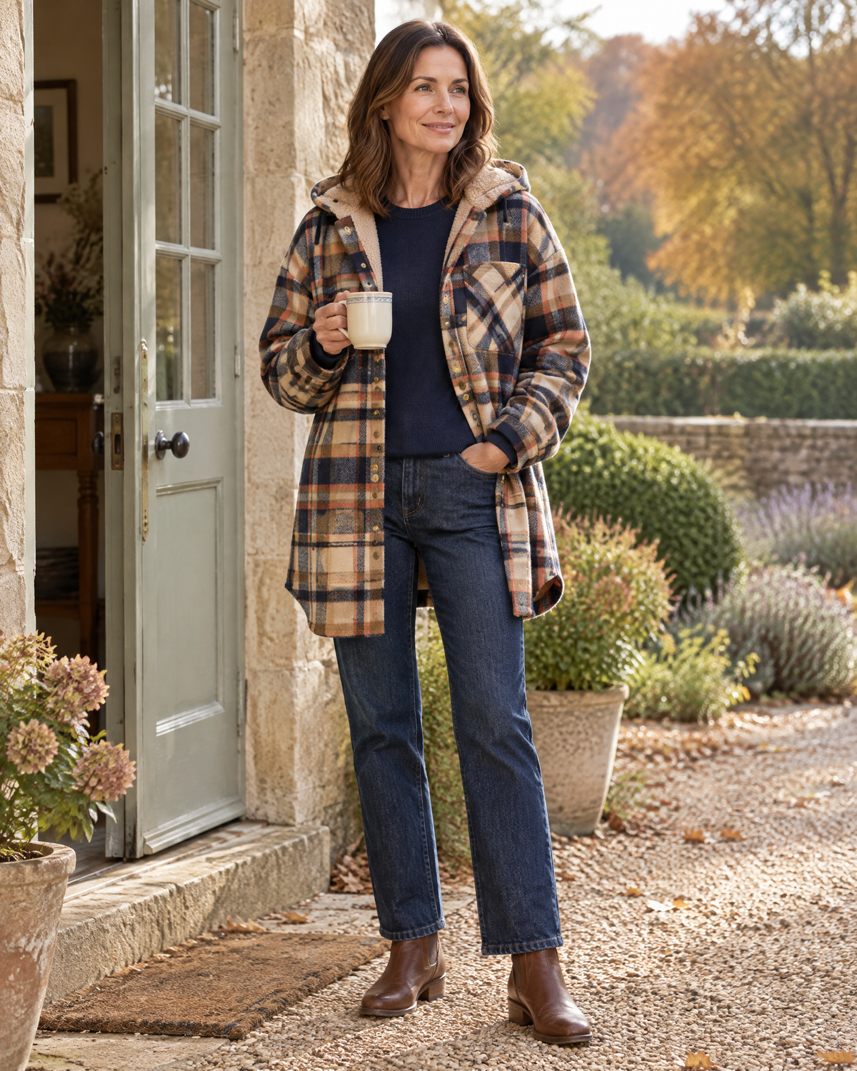 Windermere shirt jacket worn open over a navy jumper, mid-thigh length